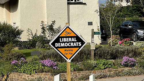 Liberal Democrat skateboard outside cottage
