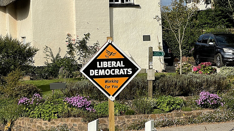 Liberal Democrat skateboard outside cottage