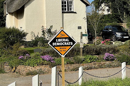 Liberal Democrat skateboard outside cottage
