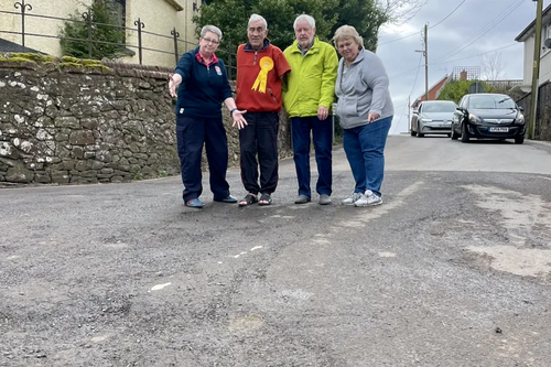 Frank Letch and local Bow residents examine road surface