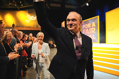 Ed Davey waving to conference