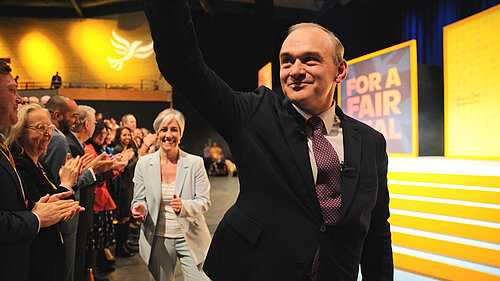 Ed Davey waving to conference